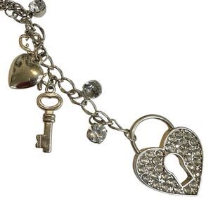 Silver tone heart and key long charm necklace